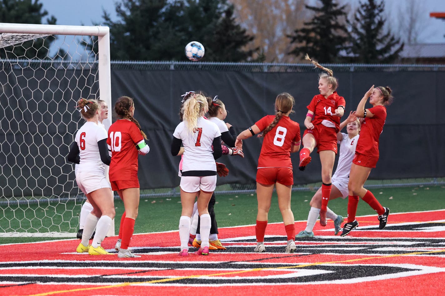 Benilde-St. Margaret's Siena Carver (14) scores off of a corner kick in the first half to give the Red Knights a 1-0 lead early in the first half. Photo by Cheryl A. Myers, SportsEngine