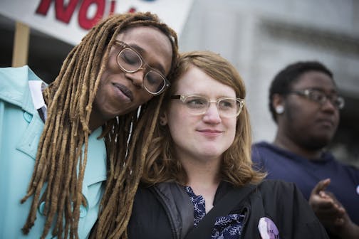 Kya Concepcion, left, and JayCee Cooper, both of Minneapolis, share a moment together during a Transgender Day of Visibility rally at the Capitol in St. Paul. Both are trans women who identify as female. "I should not fear being black and trans," said Concepcion.