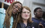 Kya Concepcion, left, and JayCee Cooper, both of Minneapolis, share a moment together during a Transgender Day of Visibility rally at the Capitol in S