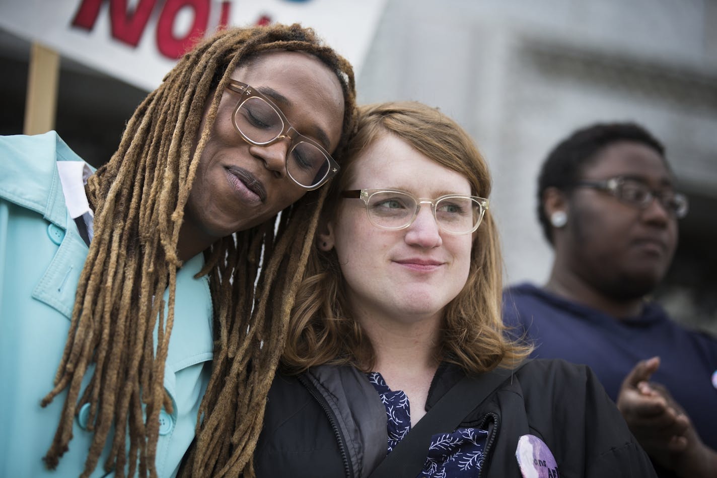 Kya Concepcion, left, and JayCee Cooper, both of Minneapolis, share a moment together during a Transgender Day of Visibility rally at the Capitol in St. Paul. Both are trans women who identify as female. "I should not fear being black and trans," said Concepcion.