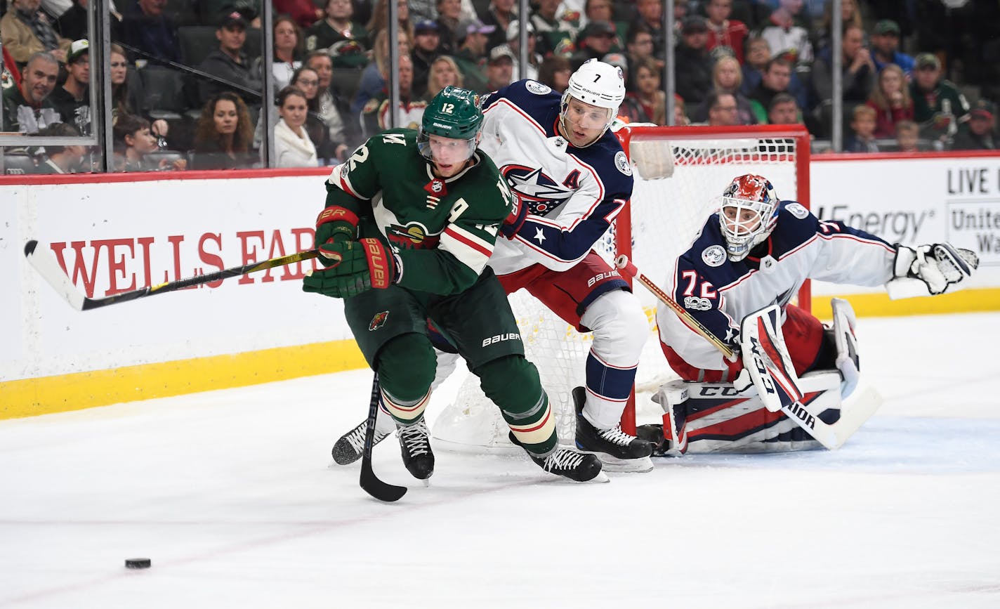 Minnesota Wild center Eric Staal (12) tried to control a rebounded shot while being challenged from behind by Columbus Blue Jackets defenseman Jack Johnson (7) in the third period. ] AARON LAVINSKY &#xef; aaron.lavinsky@startribune.com The Minnesota Wild played the Columbus Blue Jackets on Saturday, Oct. 14, 2017 at Xcel Energy Center in St. Paul, Minn.