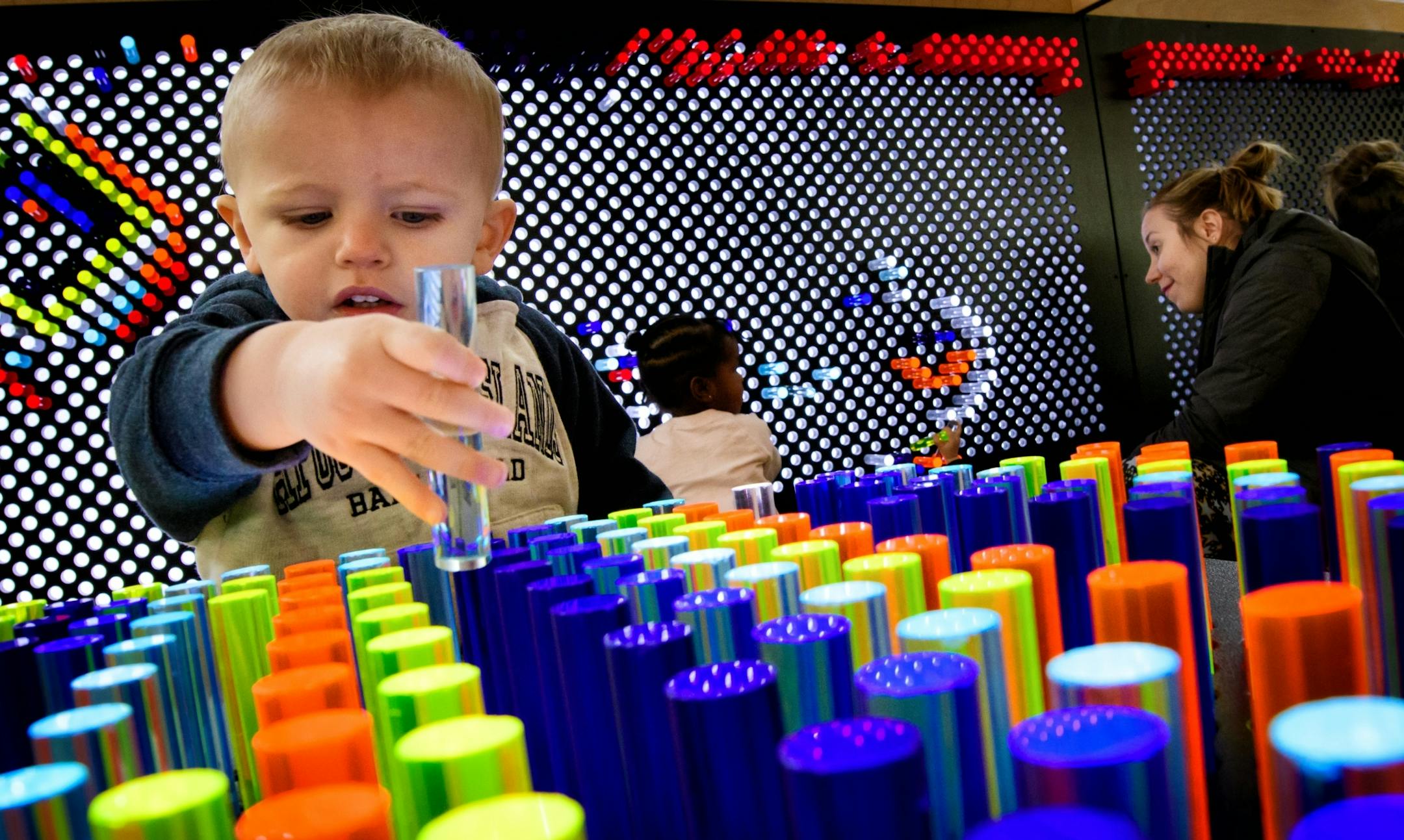 Kilik Lom, 2, played with the multicolor oversized light brite at the Brooklyn Park library.