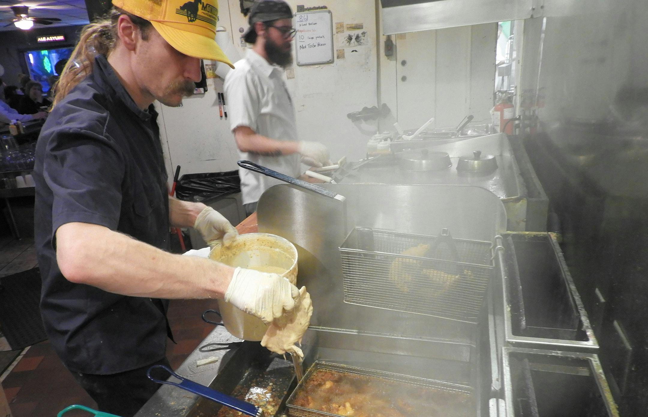 Fry master Evan Christiansen drops a piece of battered cod into a steaming fryer in the small kitchen at Dexter’s Pub in Madison. The unpretentious eatery has been voted the best fish fry in Wisconsin’s capital city. (Jay Jones/Chicago Tribune/TNS)