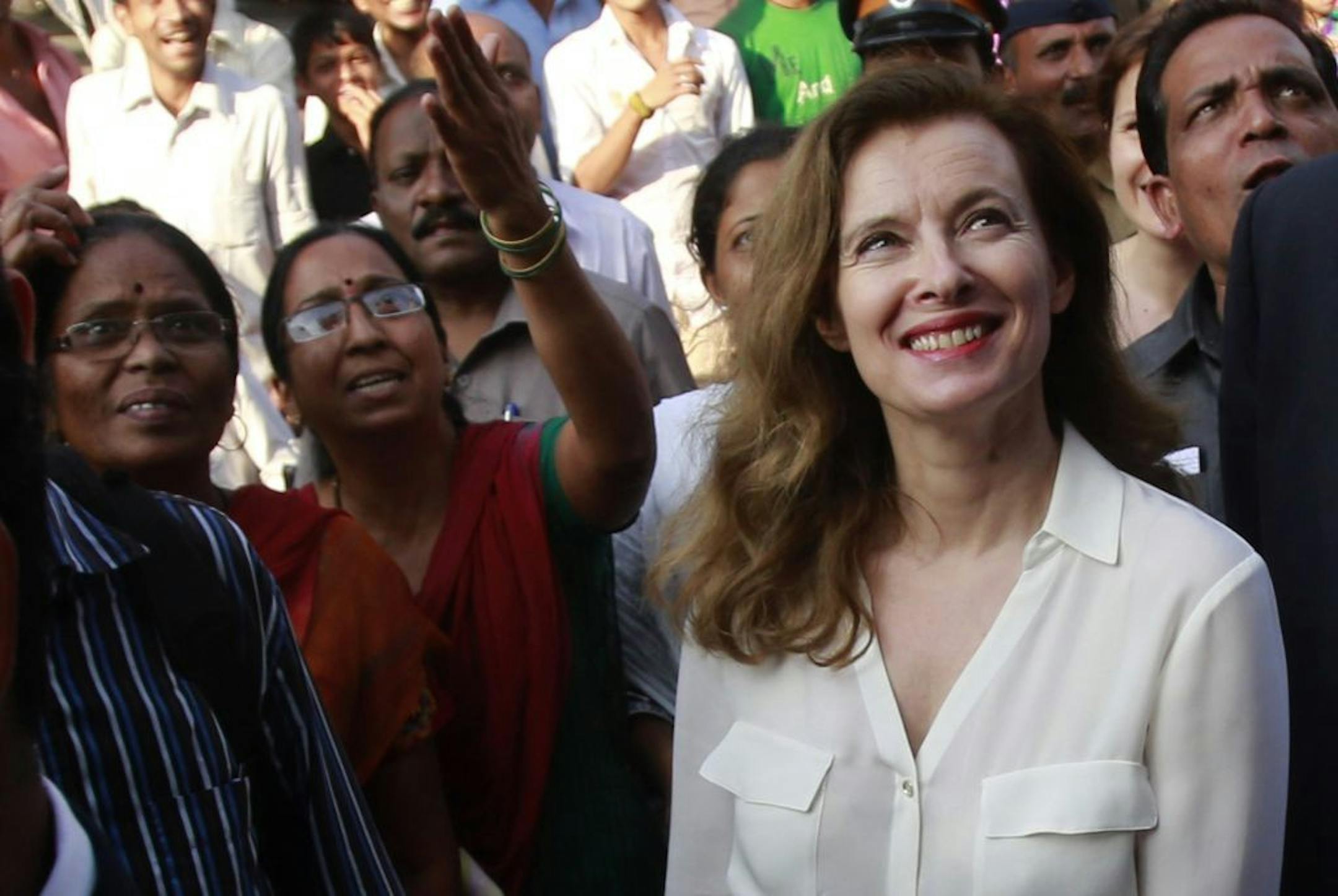 France's former first lady Valerie Trierweiler smiles as she watches children in Mumbai, India, Tuesday, Jan. 28, 2014.