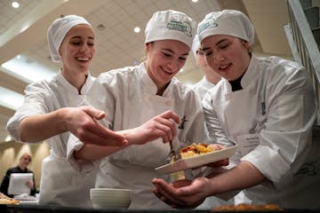 Monticello High School teammates work on their entree during the 18th annual Minnesota ProStart Invitational. Students were judged by local chefs on t