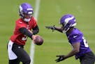Vikings quarterback J.J. McCarthy hands off the ball to running back DeWayne McBride during a rookie minicamp practice May 10.