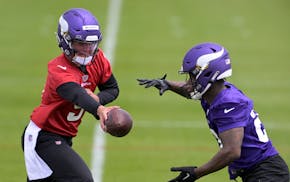 take control of the presentation teams Vikings quarterback J.J. McCarthy hands off the ball to running back DeWayne McBride during a rookie minicamp practice May 10.
