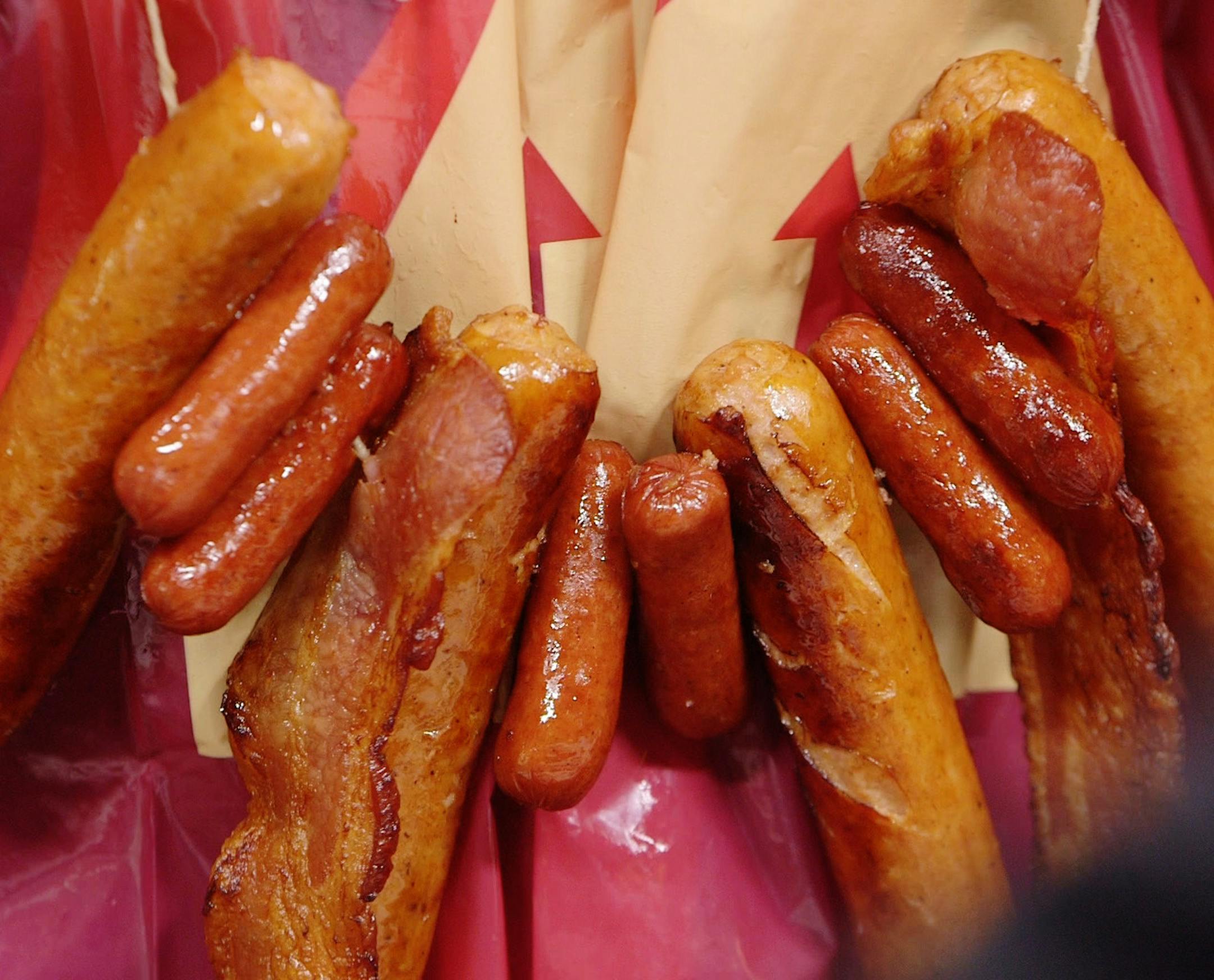 ] MARK VANCLEAVE &#xef; mark.vancleave@startribune.com * Amelia Rayno and Tom Horgen demonstrate how to make meat necklaces.