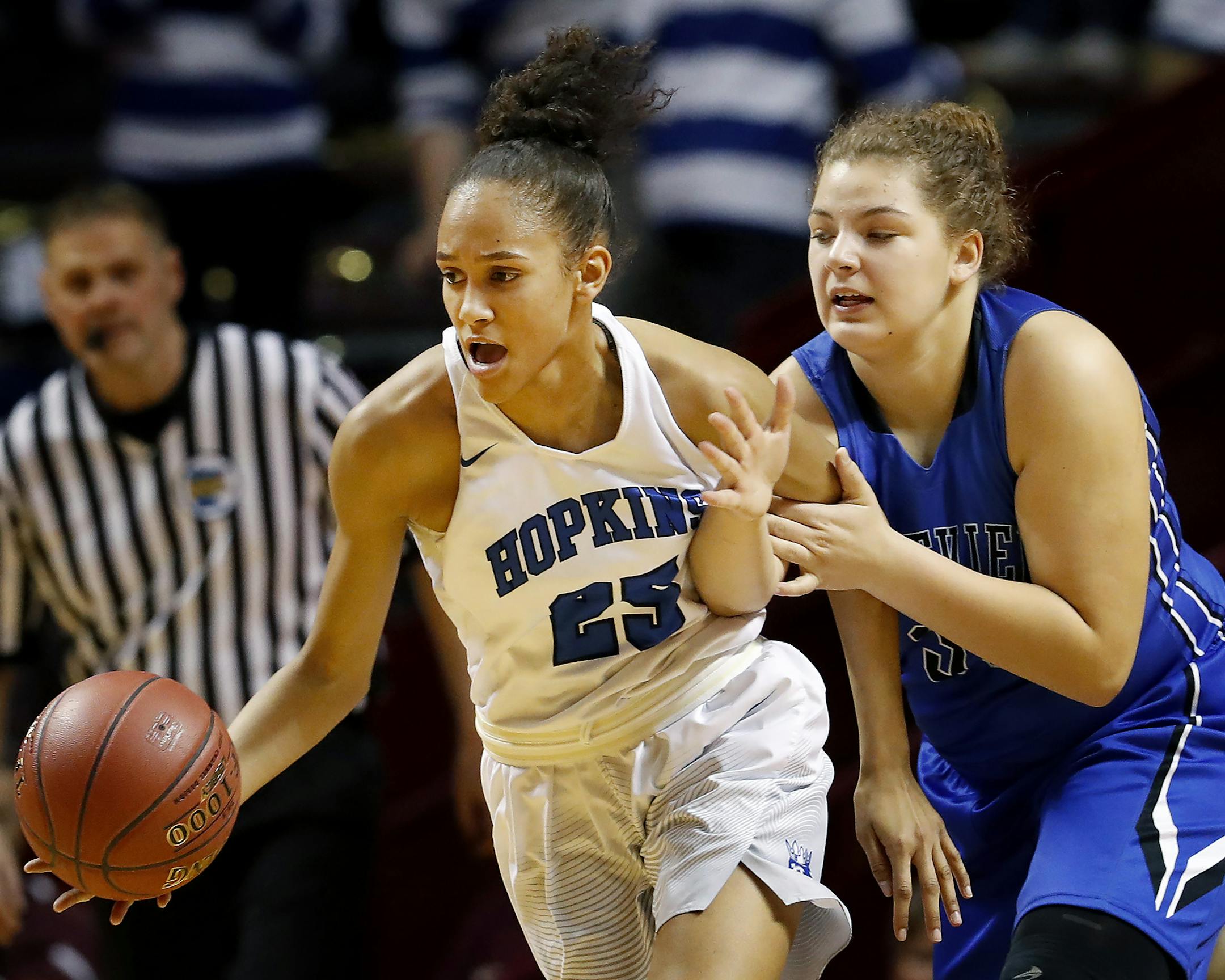 Angie Hammond (25) of Hopkins and Miranda Crenshaw (33) of Eastview fought for the ball in the first half. ] CARLOS GONZALEZ ï cgonzalez@startribune.com - March 16, 2017, Minneapolis, MN, Williams Arena, girls high school prep basketball, semifinals game, Class 4A semifinals, Hopkins vs. Eastview