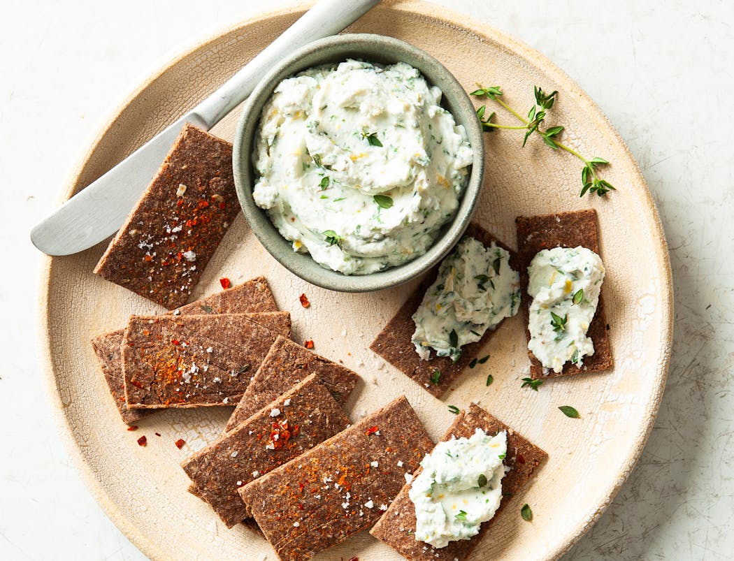 Serve Hazelnut Parmesan Crackers with herbed cream cheese.