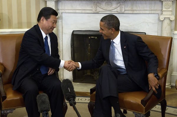 FILE -- President Barack Obama, right, shakes hands with Xi Jinping in the Oval Office at the White House in Washington, Feb. 14, 2012. Xi, who is set
