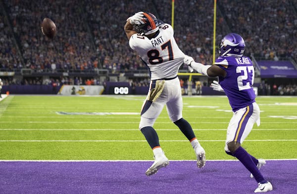 Minnesota Vikings safety Jayron Kearse tugged on the jersey of tight end Noah Fant as the Denver Broncos tried for a touchdown on the last play of the