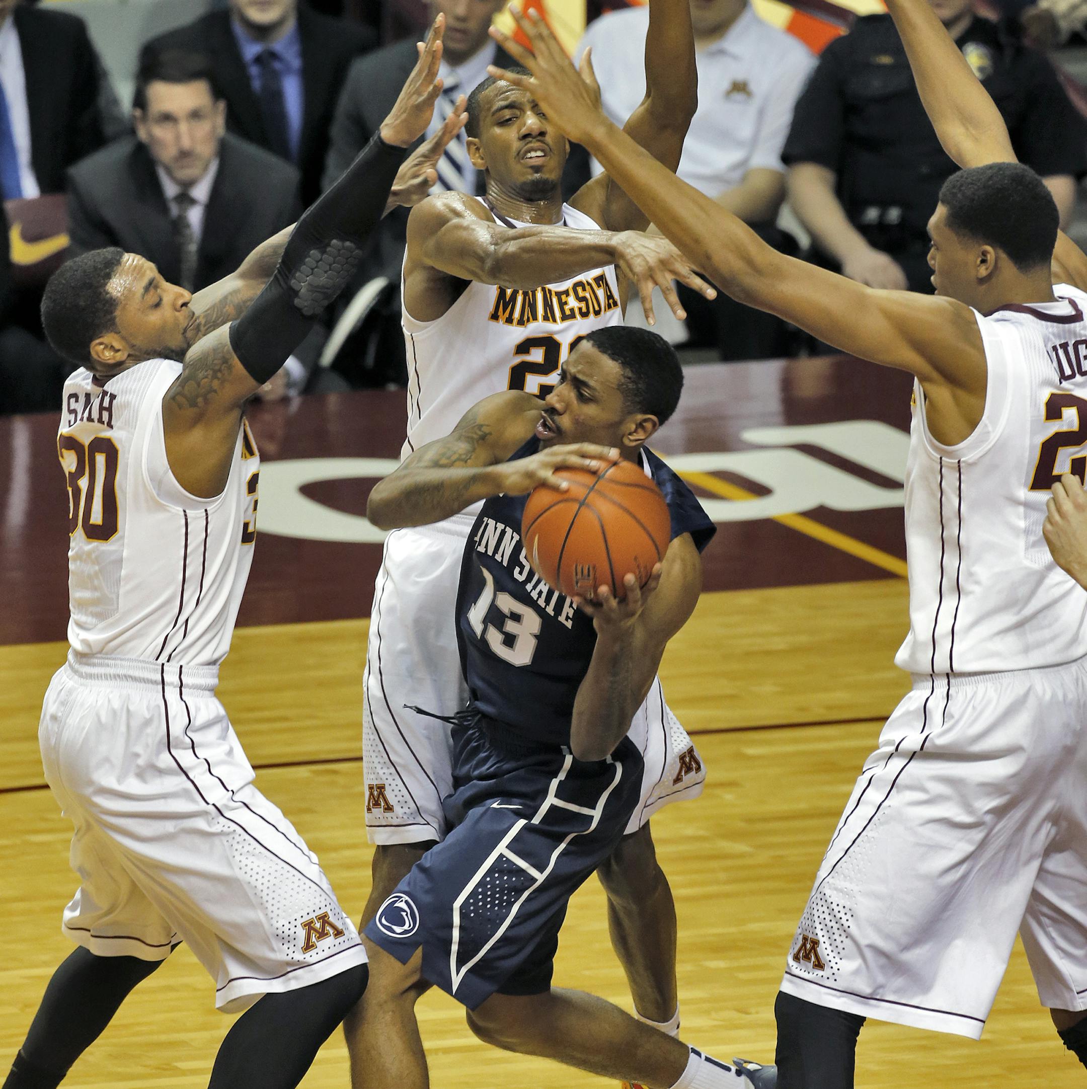 Gophers defenders (from left) Malik Smith, Austin Hollins and Charles Buggs put the defensive squeeze on Penn State's Geno Thorpe.