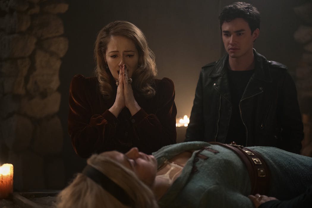 Sabrina (Kiernan Shipka, prone) is mourned by Aunt Zelda (Miranda Otto, left) and Nick Scratch (Gavin Leatherwood). Not the ending the first three seasons would lead you to expect for 'The Chilling Adventures of Sabrina.'