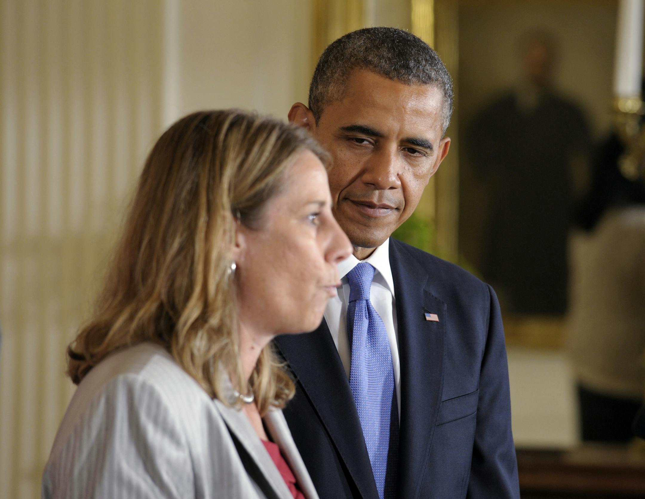 President Barack Obama, right, listens to head coach Cheryl Reeve, left, during a ceremony honoring the WNBA Champion Minnesota Lynx, Tuesday, Sept. 18, 2012, in the East Room of the White House in Washington.