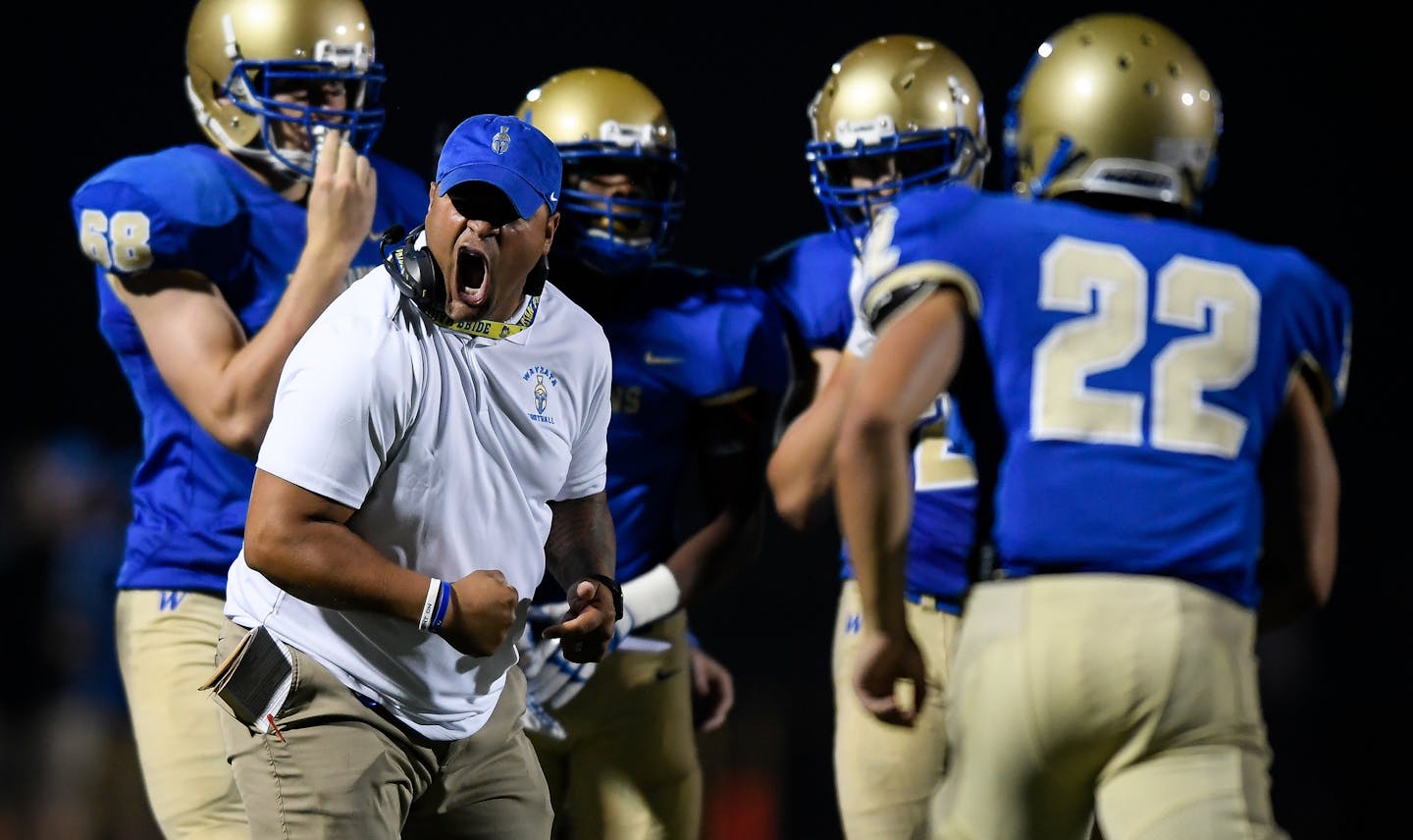 Wayzata head coach Lambert Brown celebrated a turnover on downs late in the fourth quarter against Rosemount. ] AARON LAVINSKY • aaron.lavinsky@startribune.com Wayzata played Rosemount in a high school football game on Thursday, August 31, 2017 at Wayzata High School in Plymouth, Minn.