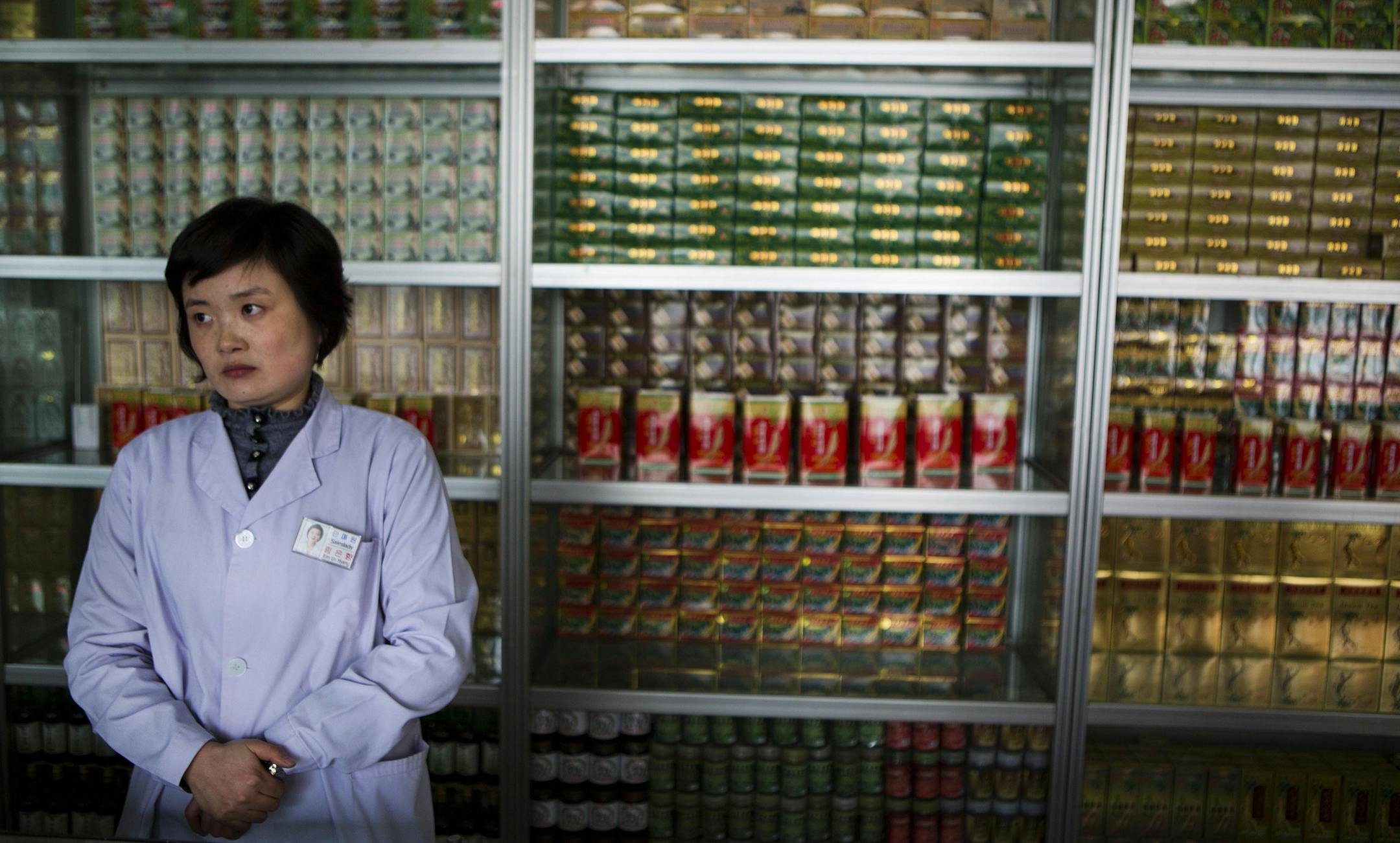 In this Feb. 21, 2013 photo, a pharmacist waits for customers at the Man Nyon Pharmacy, the nation's largest dispensary of traditional "Koryo" medicine, in Pyongyang, North Korea. North Korea began marrying traditional medicine with modern practice in the 1950s after the Korean War. (AP Photo/David Guttenfelder)