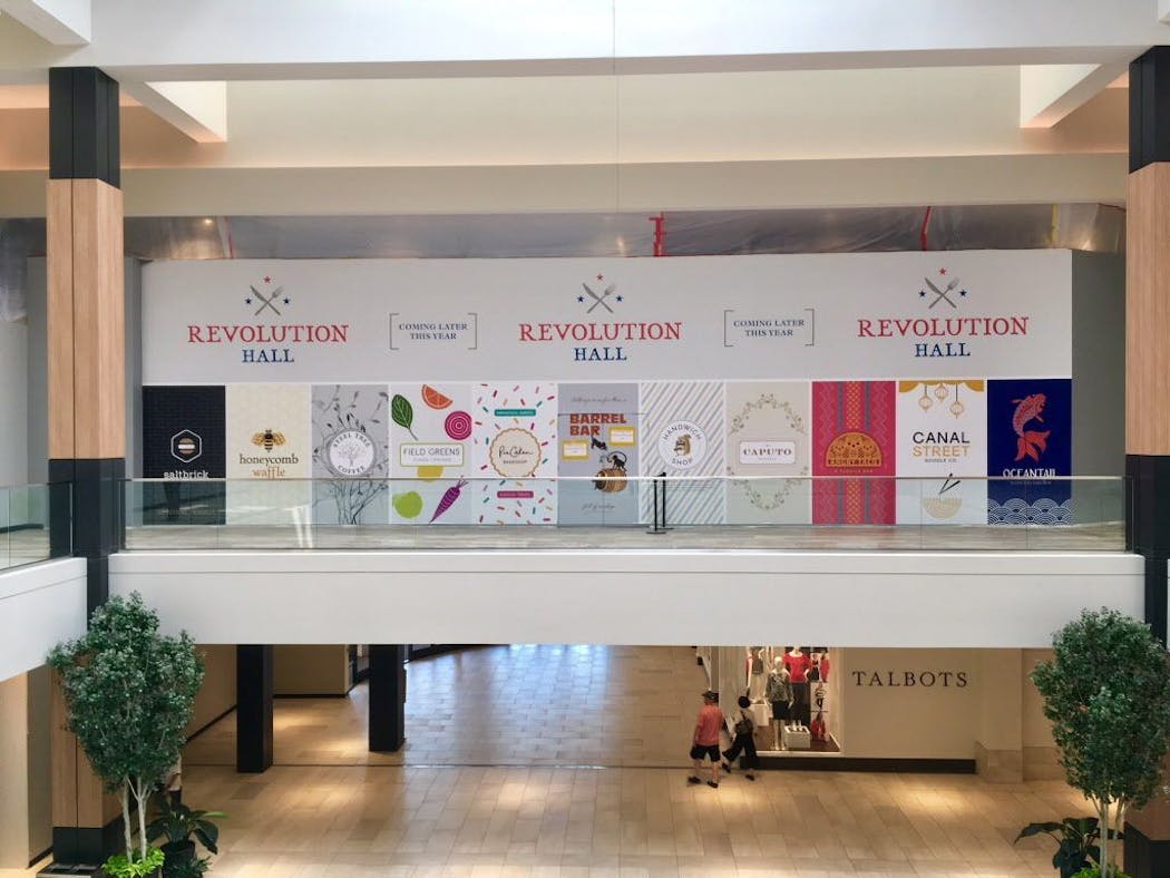A sign for the new Revolution Hall showcases some of the restaurants that will be featured in the new food hall in Rosedale Mall.