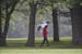 A man walked through the rain during the Class 3A state golf state tournamen at Bunker Hills Golf Course in Coon Rapids, Minn., on Tuesday, June 11, 2