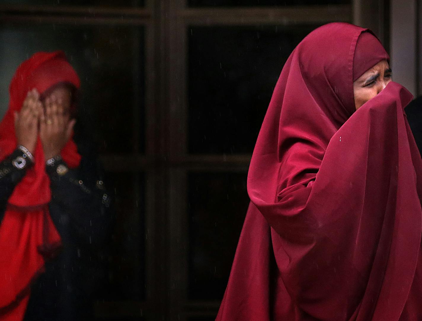 Farhiyo Mohamed, right, the mother of defendant Abdirahman Daud, and a second woman emerge in tears from the federal courthouse in Minneapolis on Friday morning after the verdict was delivered in the ISIL trial.