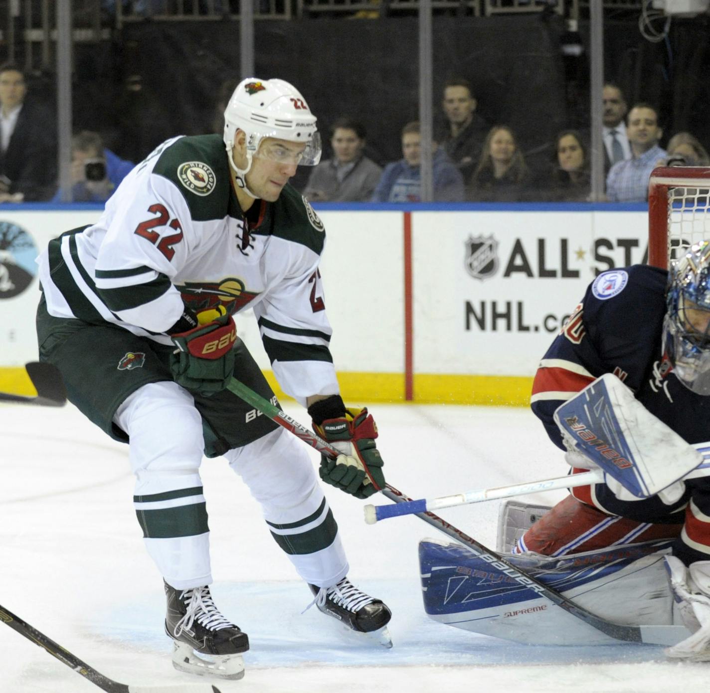 Minnesota Wild's Nino Nierderreiter, left, pressures New York Rangers goaltender Henrik Lundqvist as Lundqvist deflects the puck during the first period of an NHL hockey game Friday, Dec. 23, 2016, at Madison Square Garden in New York. (AP Photo/Bill Kostroun)