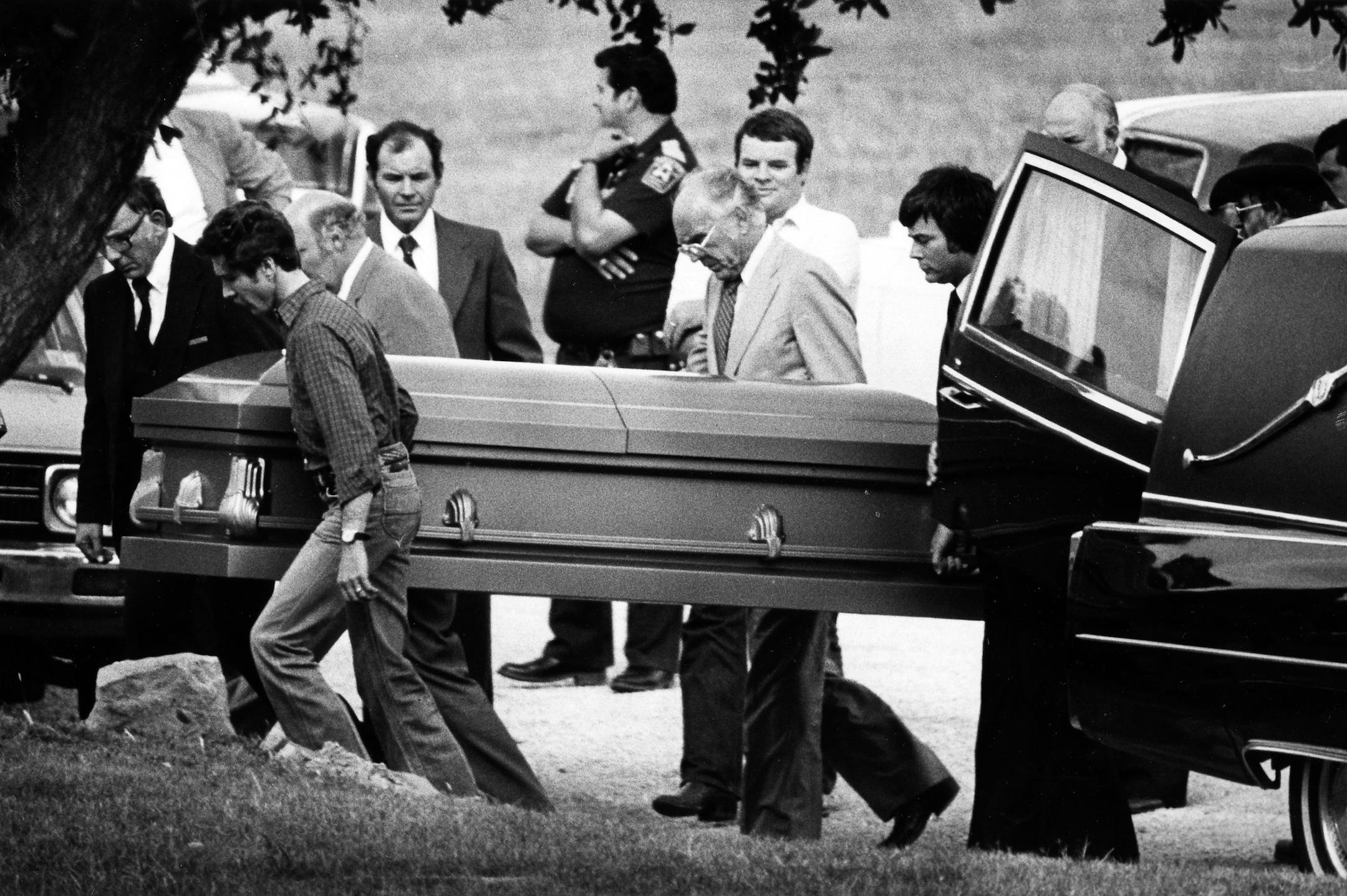 Lee Harvey Oswald's casket is unloaded from the hearse October 4, 1981. He was reburied in a new casket after being exhumed. (Jay Godwin/Dallas Morning News/MCT)
