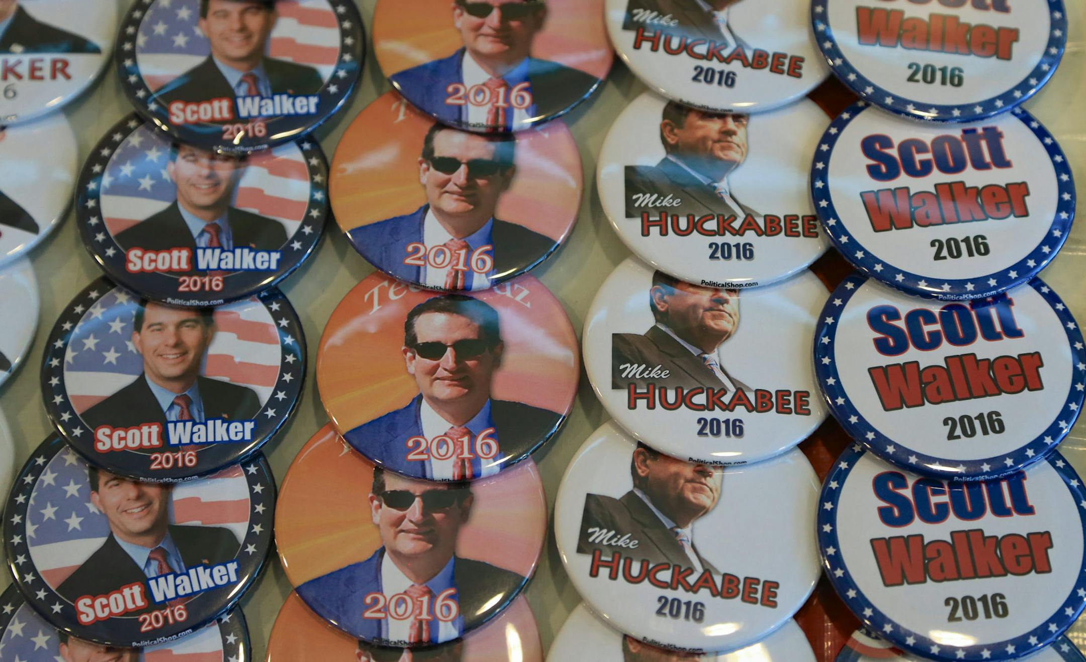 Election buttons of Republicans Scott Walker, Mike Huckabee and Ted Cruz are offered for sale at the Iowa Faith & Freedom 15th Annual Spring Kick Off, in Waukee, Iowa, Saturday, April 25, 2015. (AP Photo/Nati Harnik)