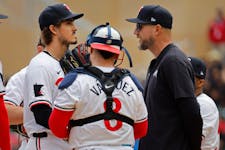Twins starting pitcher Joe Ryan, left, listens to manager Rocco Baldelli, right, before being pulled from his start against the Yankees earlier this m