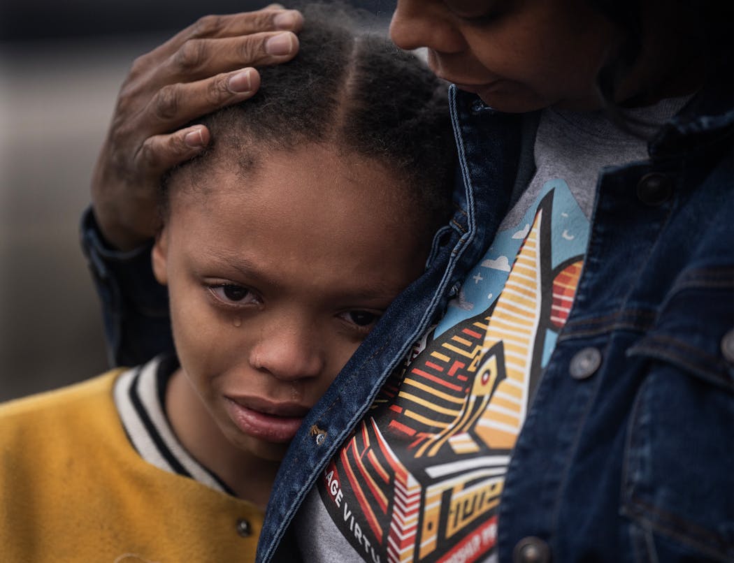 Maki Johnson,11, is comforted by his mother, Eureka Johnson, at a celebration of Sammy McDowell’s life at Shiloh Temple International in Minneapolis on Tuesday. Johnson was a manager at Sammy’s Avenue Eatery. 