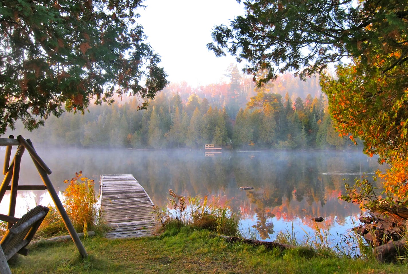 In the early morning, the mist rises off the chilly surface of Caribou Lake.