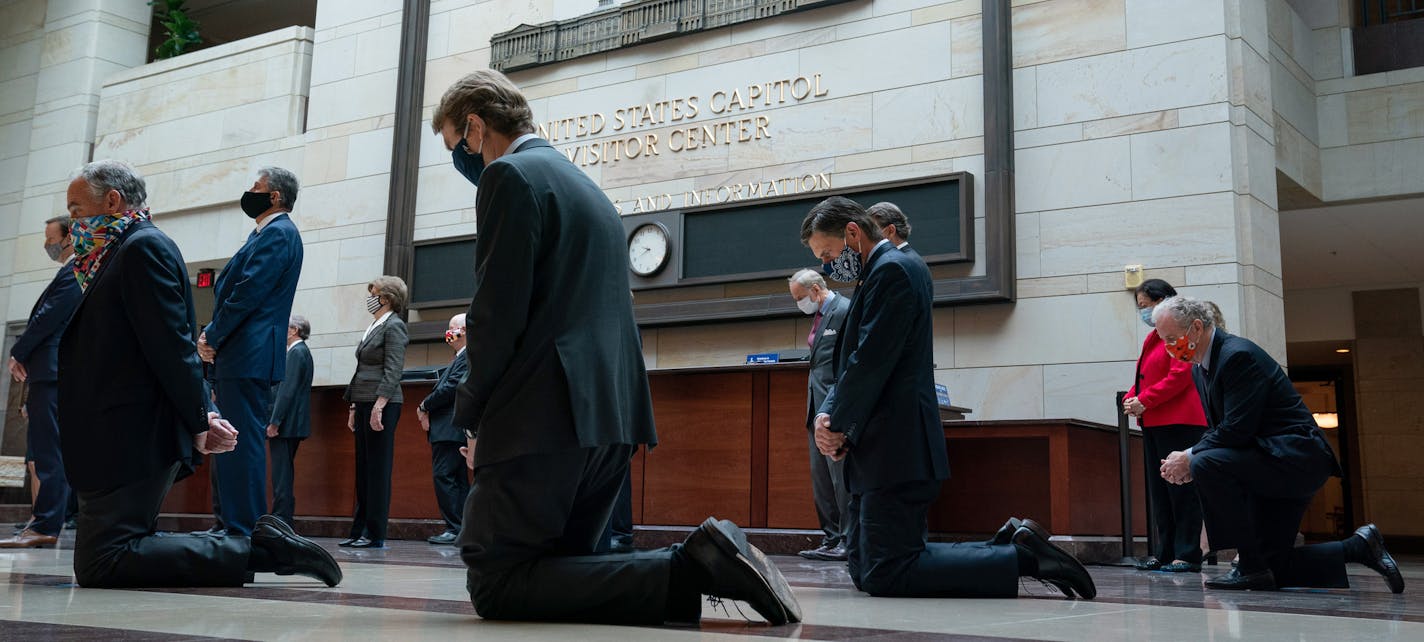 From left: Sens. Tim Kaine (D-Va.), Michael Bennet (D-Colo.), Martin Heinrich (D-N.M.), and Chris Van Hollen (D-Md.), kneel as Democratic Caucus members participate in a moment of silence in Emancipation Hall at the Capitol in Washington, Thursday, June 4, 2020, to commemorate the lives of of George Floyd, Ahmaud Arbery, and Breonna Taylor, and to stand in solidarity with Americans throughout the country protesting racial injustice. Hundreds are expected to attend a memorial service for Floyd in