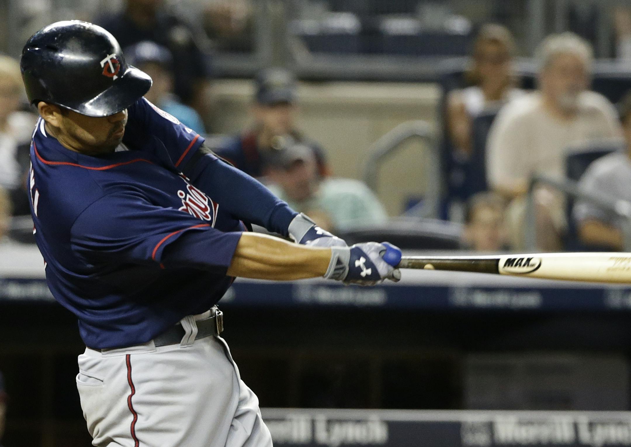 Minnesota Twins' Kurt Suzuki hits an hits an RBI double during the fifth inning of a baseball game against the New York Yankees on Tuesday, Aug. 18, 2015, in New York. (AP Photo/Frank Franklin II)