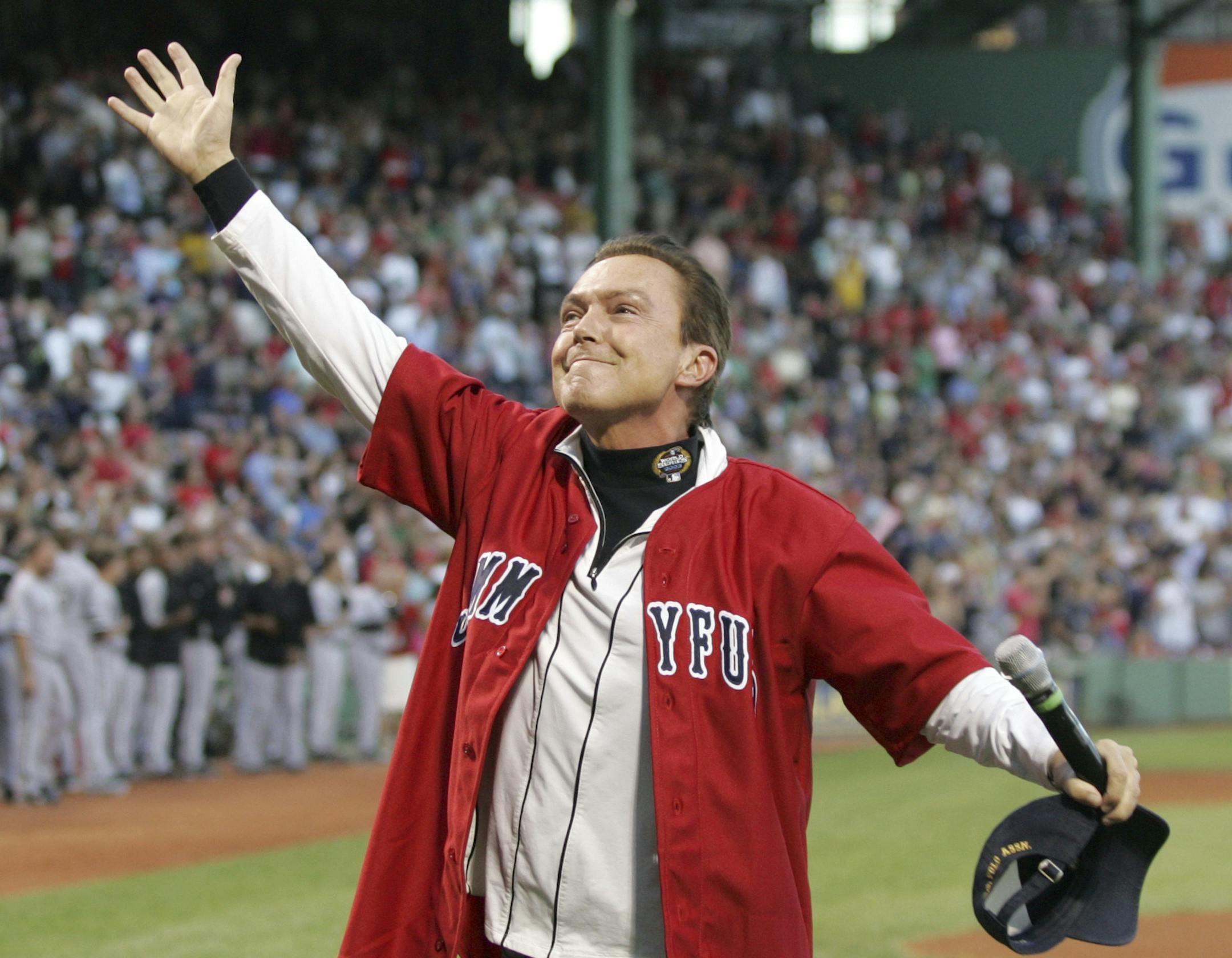 FILE - In this Aug. 27, 2009, file photo, David Cassidy reacts to the crowd after singing the national anthem before a baseball game between the Boston Red Sox and Chicago White Sox at Fenway Park in Boston. Former teen idol Cassidy of "The Partridge Family" fame has died at age 67, publicist said Tuesday, Nov. 21, 2017. (AP Photo/Mary Schwalm, File)
