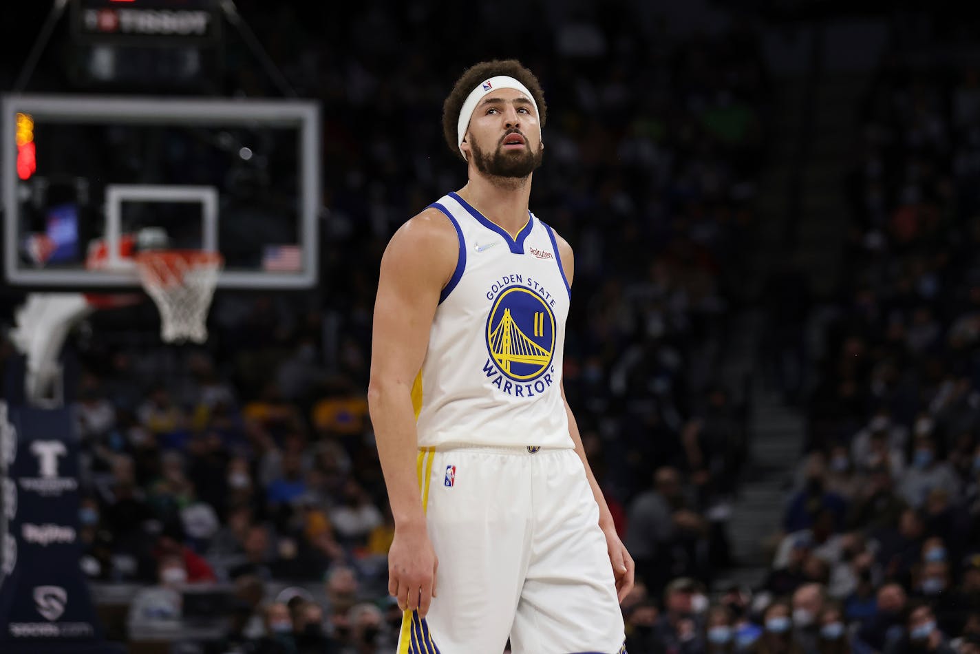 Golden State Warriors guard Klay Thompson (11) walks on the court during the first half of an NBA basketball game against the Golden State Warriors, Sunday Jan. 16, 2022, in Minneapolis. (AP Photo/Stacy Bengs)