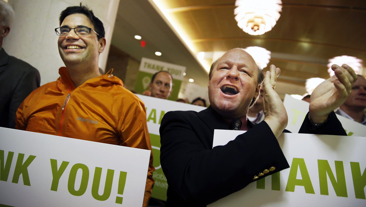 At the Mayo Clinic in Rochester, City Council Member Michael Wojcik and Jon Eckhoff of the Rochester Downtown Alliance cheered the dignitaries held up signs thanking the half-billion dollar tax deal that the state hopes will help Mayo Clinic stage a multi-billion dollar hometown makeover.] richard tsong-taatarii@startribune.com