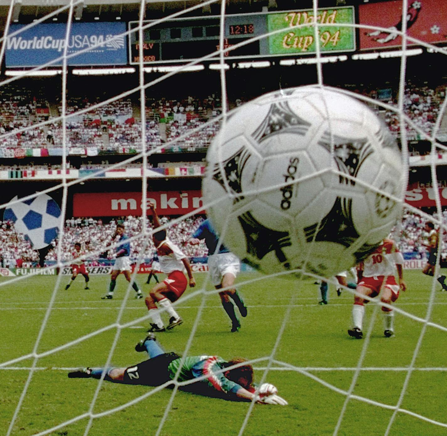 Italy's goalie Luca Marchegiani lies on the grass after Mexico's Marcelino Bernal, left of ball, blasted the ball into the net during the Italy and Mexico Group E World Cup match Tuesday, June 28, 1994, at Washington's RFK Stadium. Italy and Mexico tied 1-1 and Mexico will advance to the next round. (AP Photo/Doug Mills) ORG XMIT: APHSWCW117