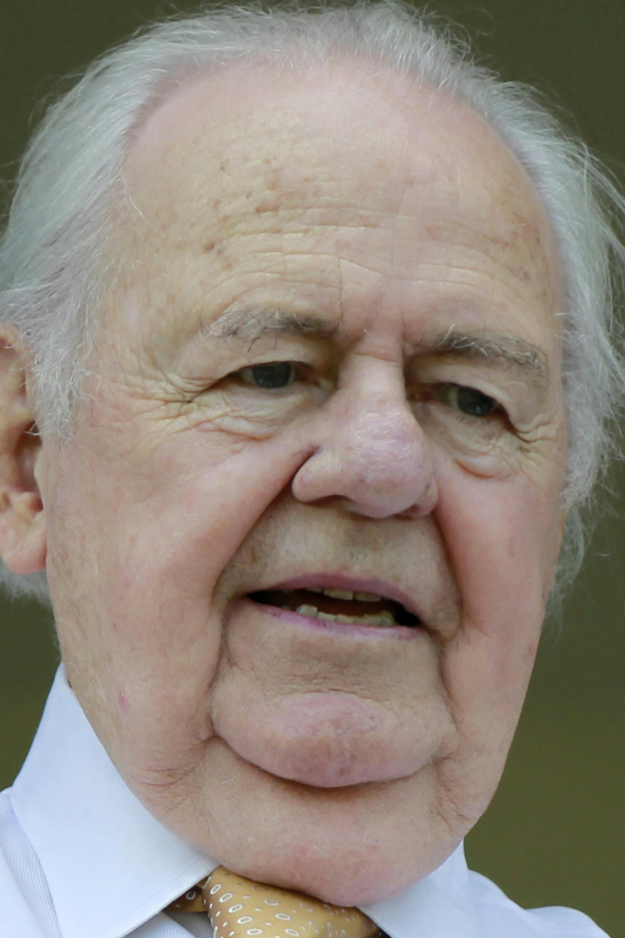 FILE - In this Aug. 1, 2012 file photo, Tom Benson, owner of the New Orleans Saints NFL team and New Orleans Pelicans NBA team, watches quarterback Drew Brees and his wife play with their children after training camp at their NFL football training facility in Metairie, La. One of the people most responsible for bringing NBA All-Stars back to the Big Easy this weekend is an 86-year-old man who wasn't that into basketball for much of his life. He is Tom Benson. And in New Orleans, NBA fans and com