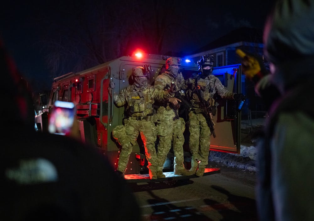 Federal officers retreated after protesters halted the progress in an armored vehicle on Lyndale Ave. N. at 23rd Ave. in Minneapolis on Jan. 14. Protesters converged on a few blocks in north Minneapolis after it was reported a federal agent shot a man Wednesday night.