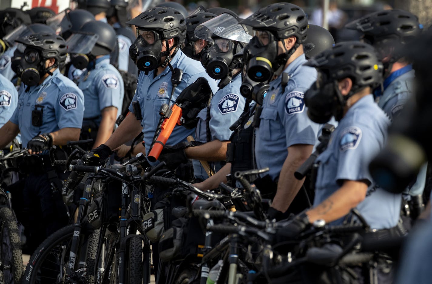 FILE - In this May 27, 2020, file photo, police gather en masse as protests continue at the Minneapolis 3rd Police Precinct in Minneapolis. More than 150 Minneapolis police officers have started the process of filing for disability claims since the death of George Floyd and the ensuing unrest in the city, with the majority citing post-traumatic stress disorder as the reason for their planned departure, according to an attorney representing the officers. (Carlos Gonzalez/Star Tribune via AP, File