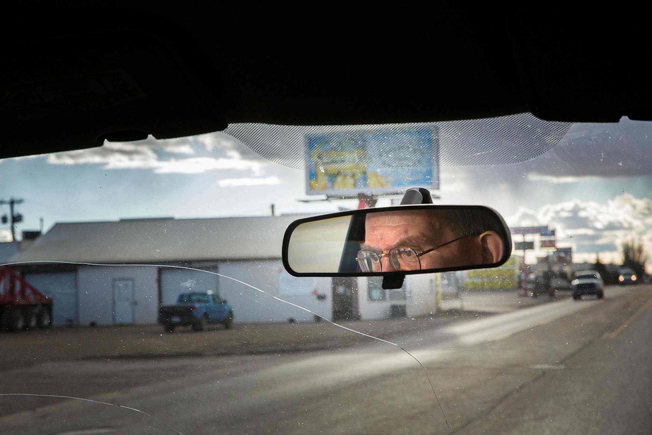 Chuck Wilder, the owner of Books on Broadway and a lifelong Williston resident, drives in downtown Williston, North Dakota on Wednesday, April 1, 2015.