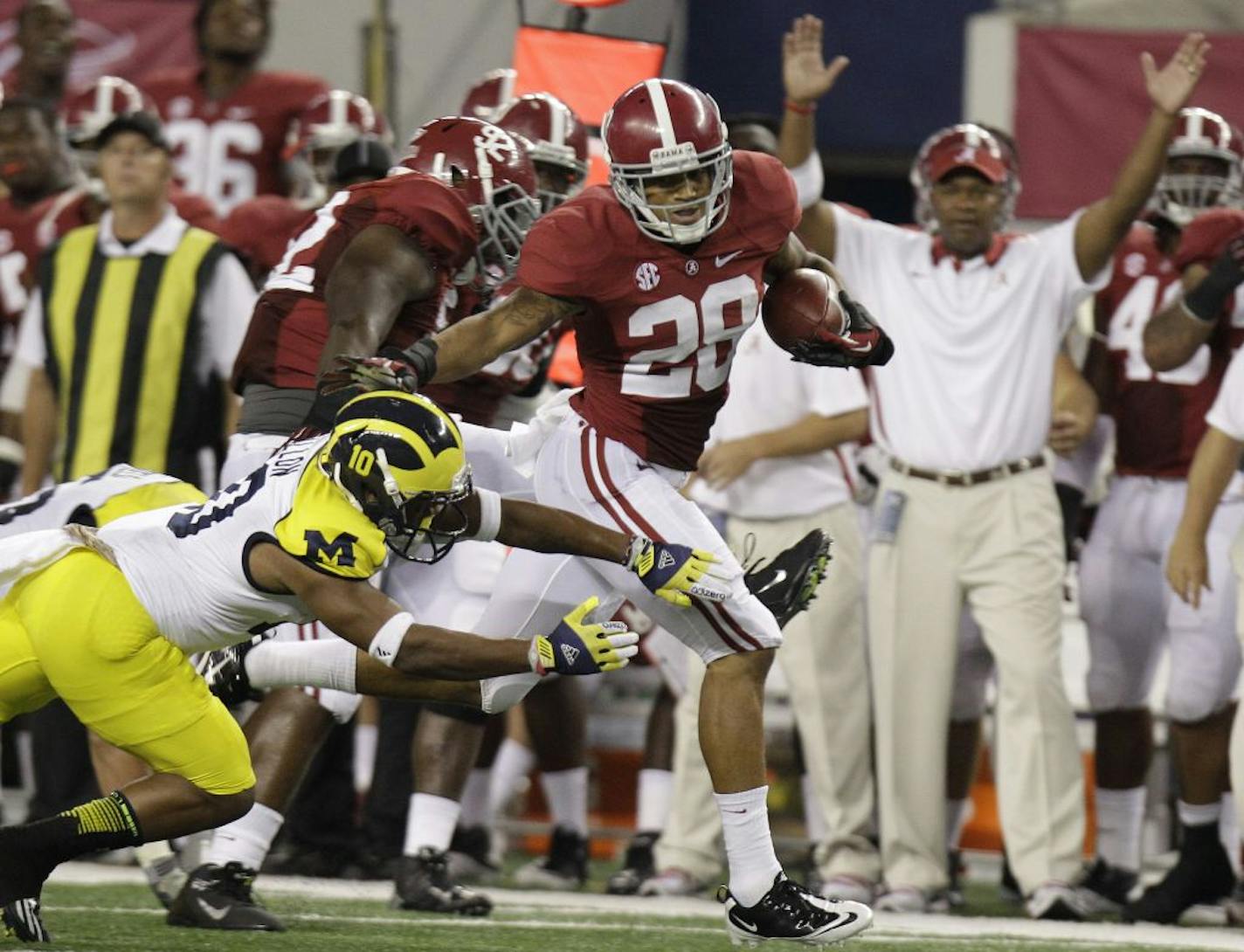 Alabama defensive back Dee Milliner (28) runs back a turnover past Michigan wide receiver Jeremy Gallon (10) during in the first half of an NCAA college football game at Cowboys Stadium in Arlington, Texas, Saturday, Sept. 1, 2012.