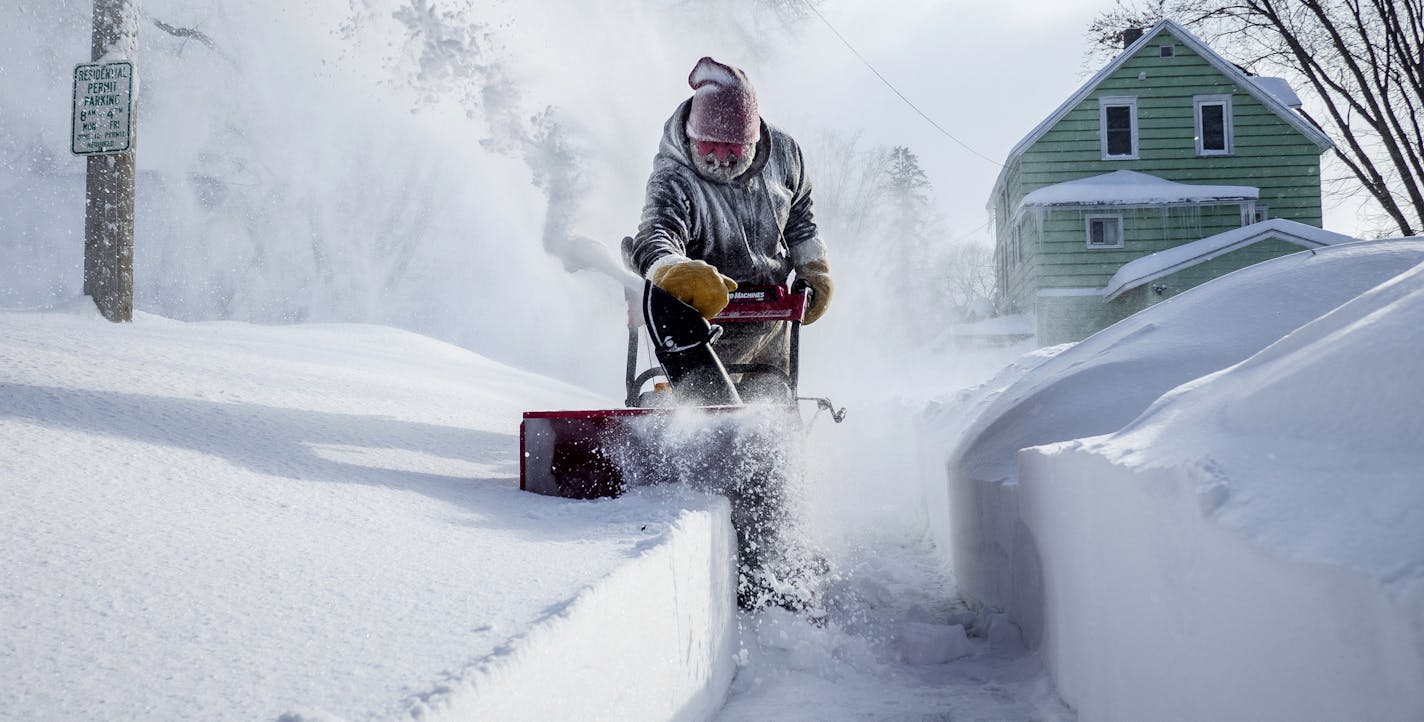 Michael Mueller snow blows the sidewalk near his house Sunday, Feb. 24, 2019, in Rochester, Minn., after heavy snow overnight. ( Joe Ahlquist/The Rochester Post-Bulletin via AP)