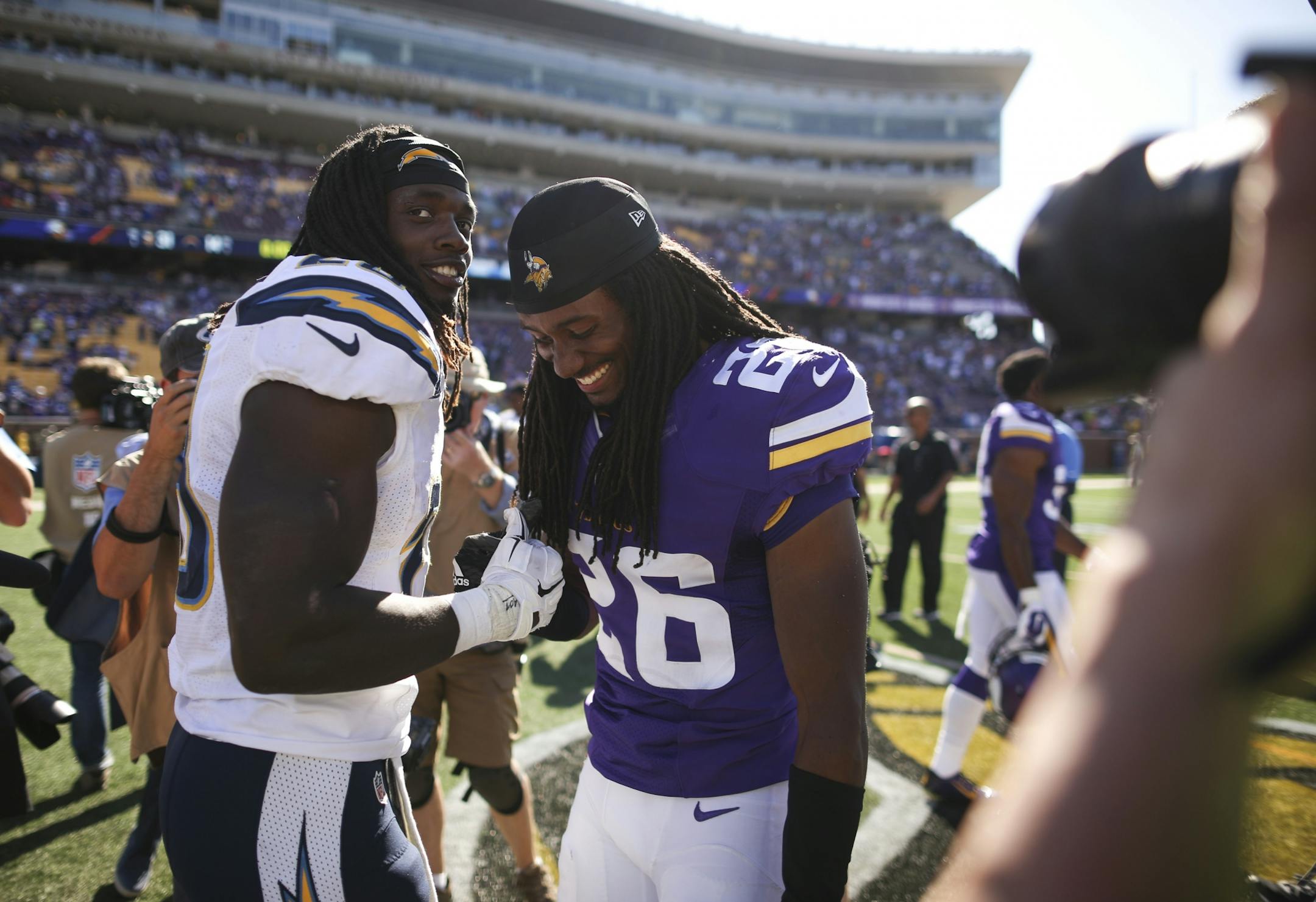 Former Kenosha (WI) High School teammates, San Diego Chargers running back Melvin Gordon, left, and Vikings cornerback Trae Waynes (26) greet each other after the game Sunday afternoon.