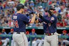Minnesota Twins' C.J. Cron (24) and Marwin Gonzalez (9) celebrate Chron's two-run home run that scored Gonzalez in the first inning of a baseball game