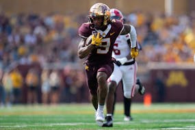 Minnesota wide receiver Daniel Jackson (9) runs after catching a pass to score a 37-yard touchdown during the second half of an NCAA college football 