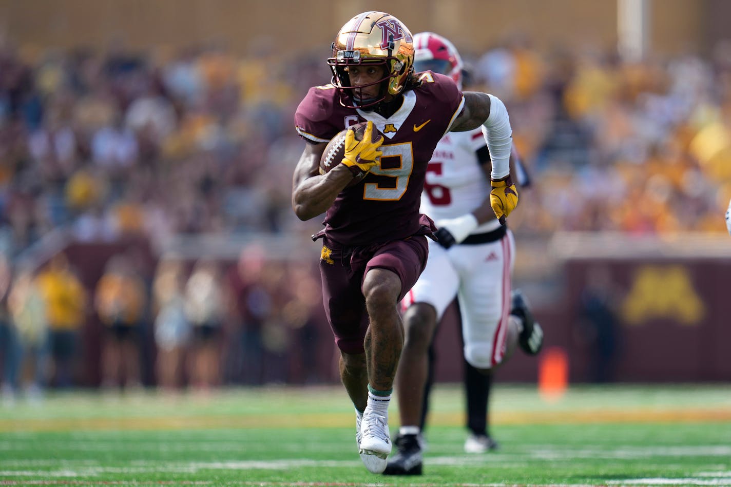 Minnesota wide receiver Daniel Jackson (9) runs after catching a pass to score a 37-yard touchdown during the second half of an NCAA college football game against Louisiana Lafayette, Saturday, Sept. 30, 2023, in Minneapolis. (AP Photo/Abbie Parr)