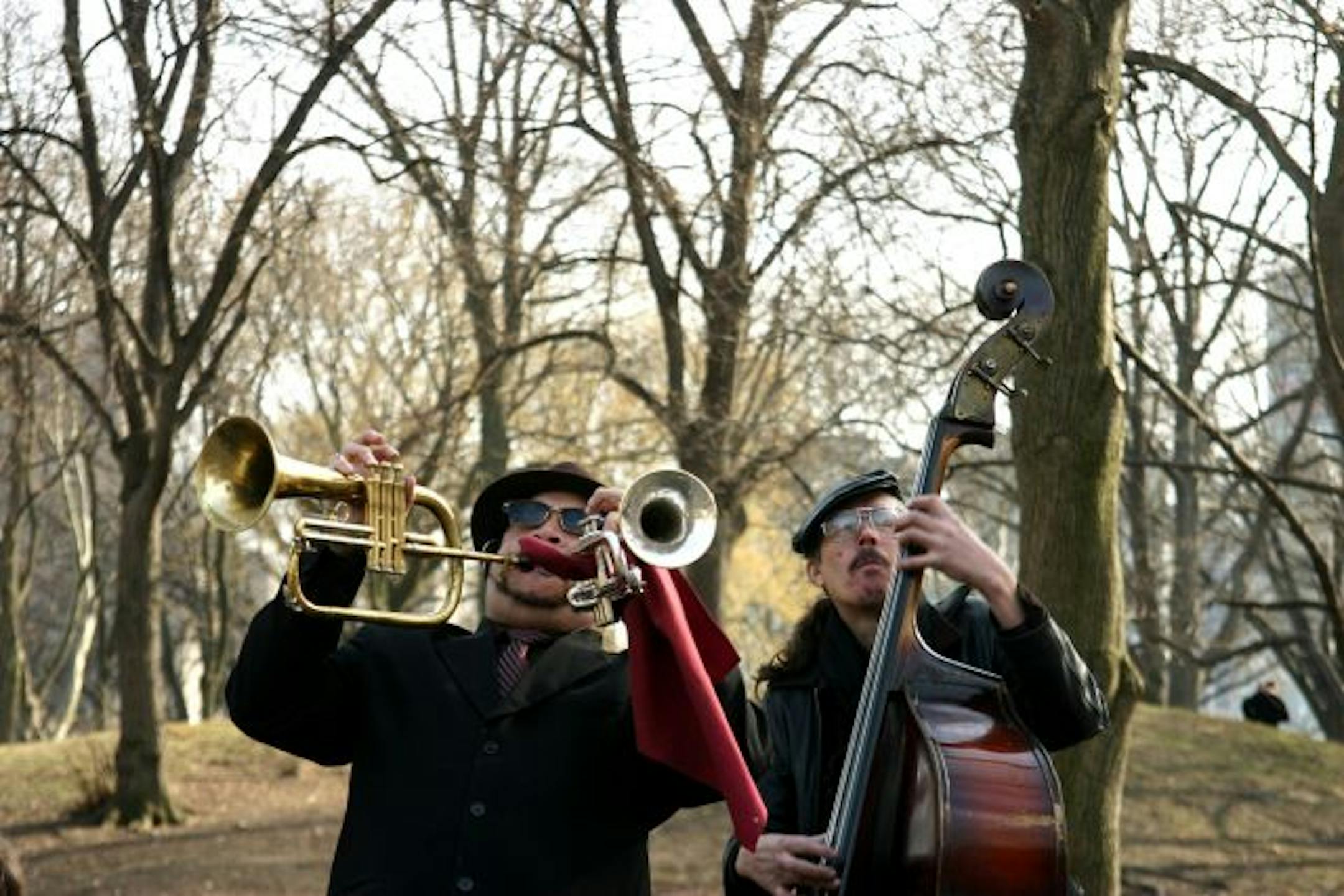 Members of a jazz band, including one playing a flugelhorn and a trumpet simultaneously, perform in Central Park in New York on Saturday, March 21, 2009.