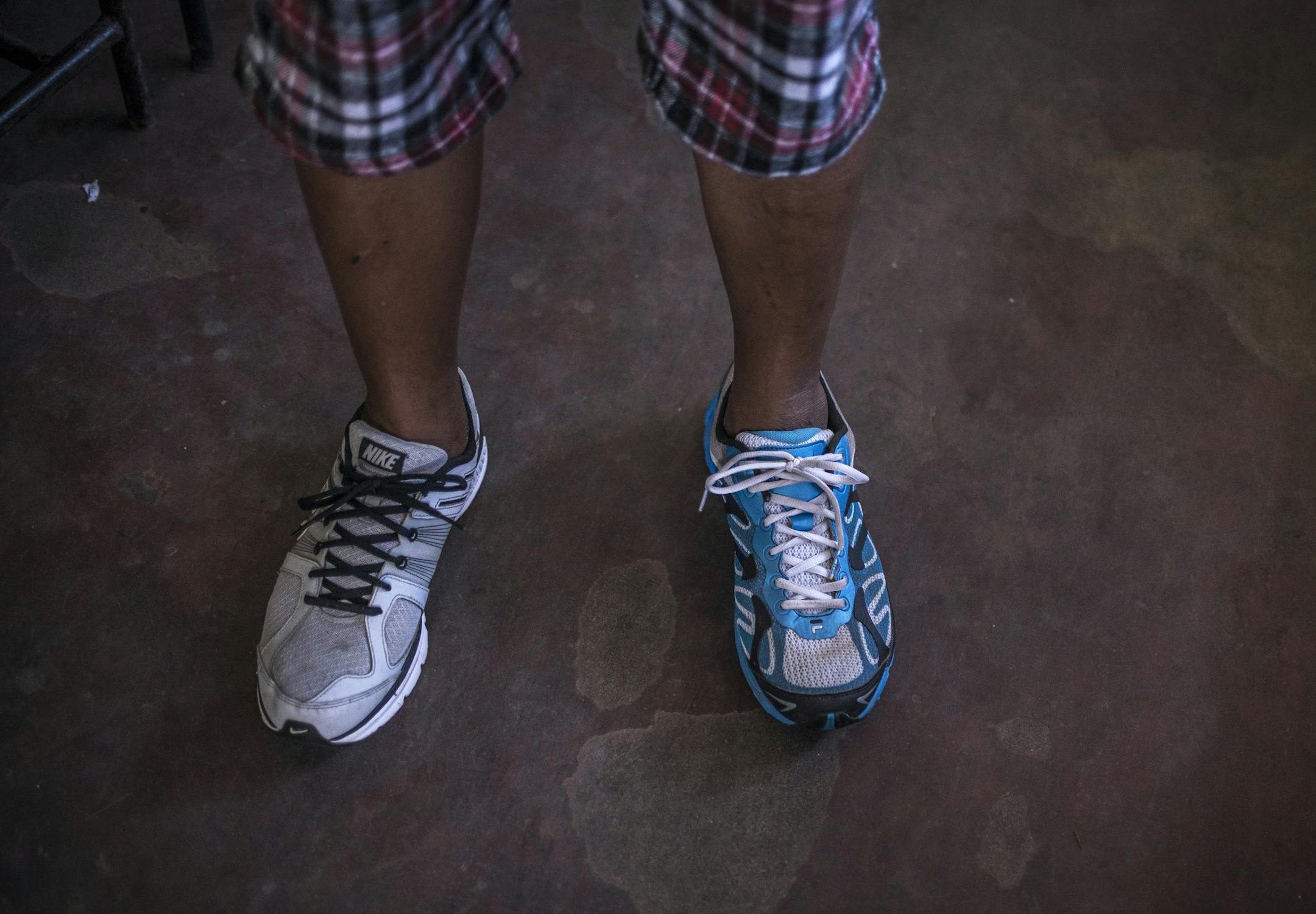 A typhoon victim wears two different shoes he managed to find after the storm in Tacloban, the Philippines, Nov. 19, 2013. More than a week after Typhoon Haiyan, the Philippines faces a multitude of questions about the needs of some 13 million people affected by the storm. (Sergey Ponomarev/The New York Times)