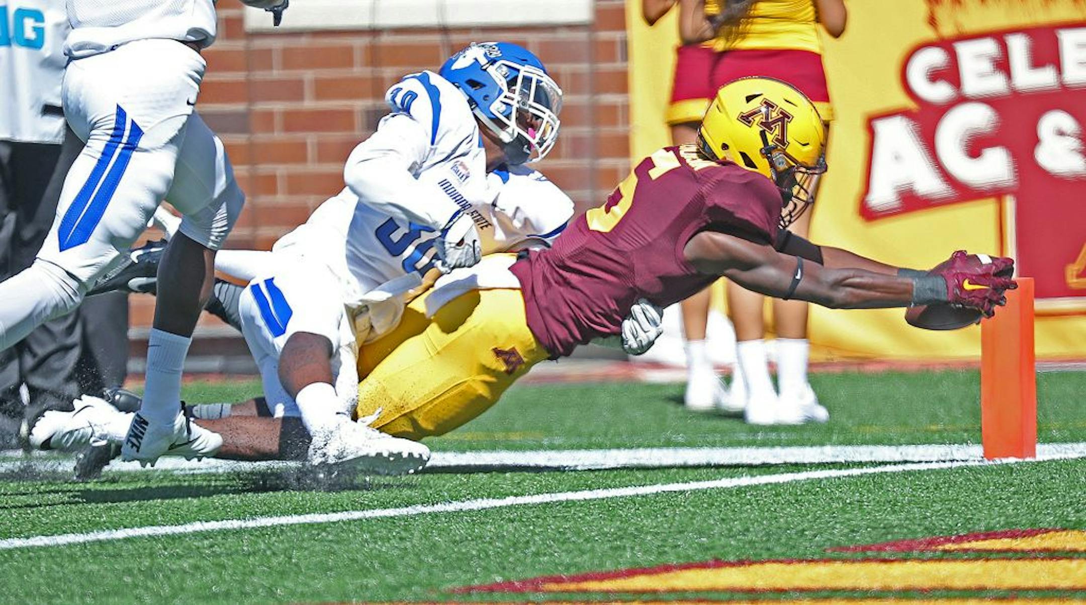 Minnesota Gophers wide receiver Tyler Johnson reached into the end zone for a touchdown despite defensive pressure by Indiana State's defensive back Kevin Beacham in the second quarter as the Gophers took on Indiana State at TCF Bank Stadium, Saturday, September 10, 2016 in Minneapolis, MN.