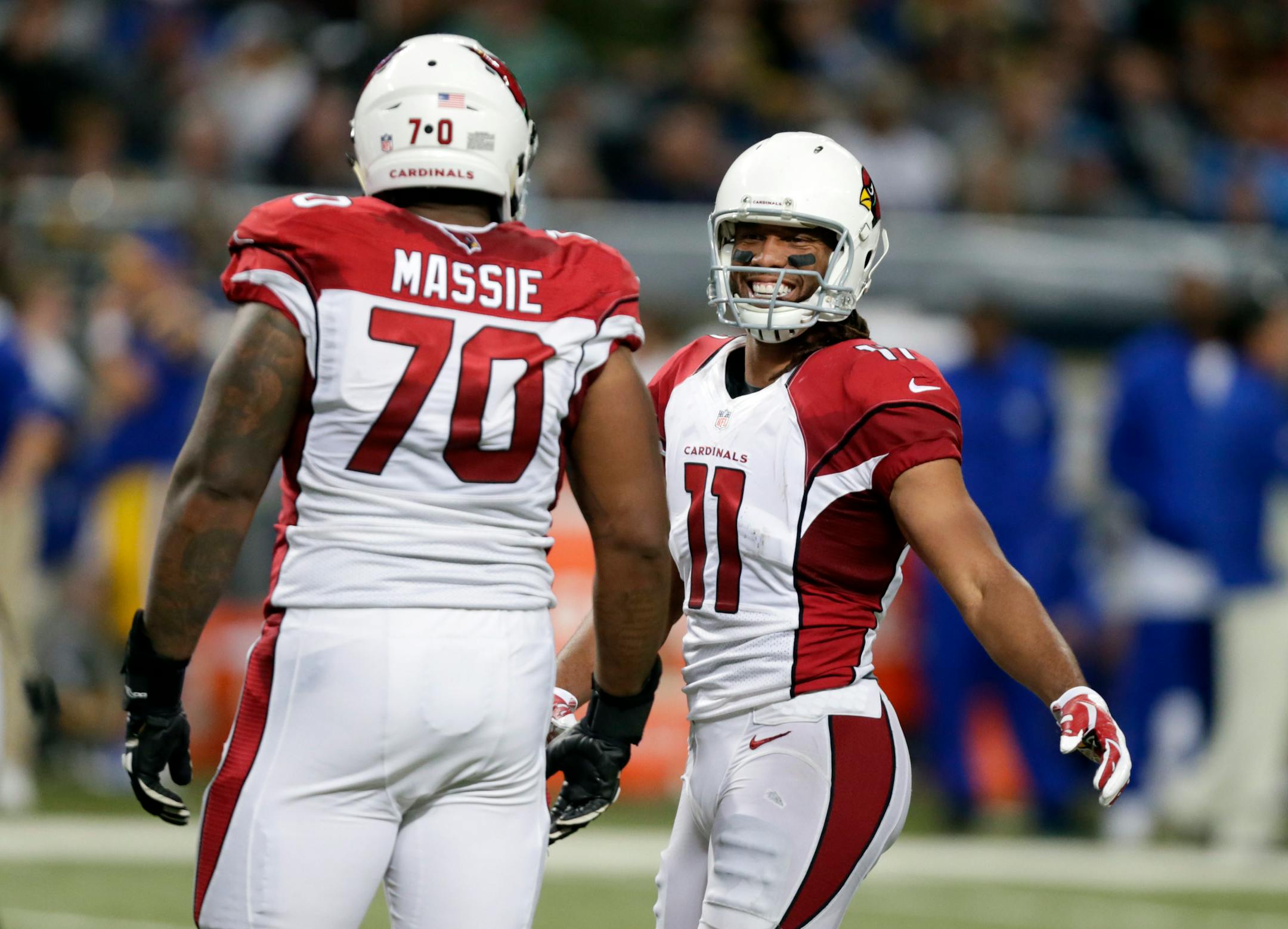 Arizona Cardinals wide receiver Larry Fitzgerald, right, is congratulated by teammate Bobby Massie after catching a pass during the third quarter against the St. Louis Rams last Sunday.